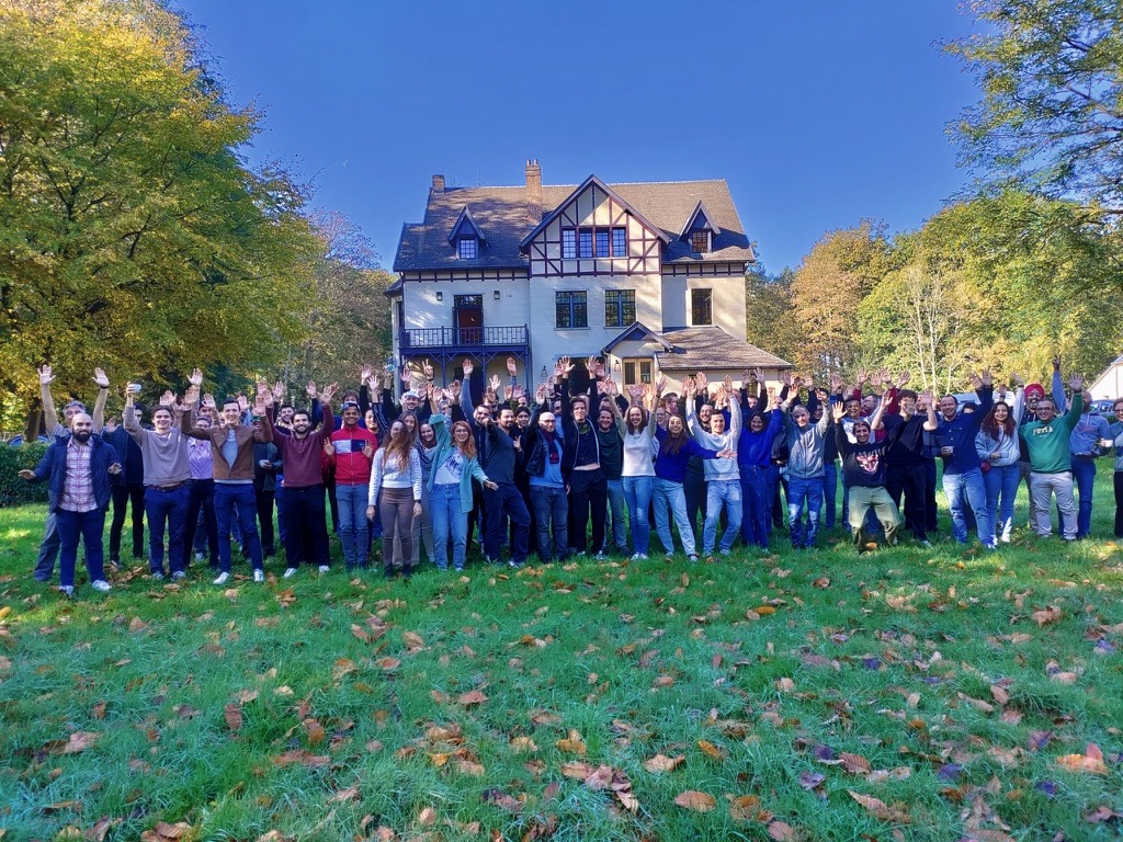 join_us Group of people from Proximus Ada taking joyful picture and raising their hands